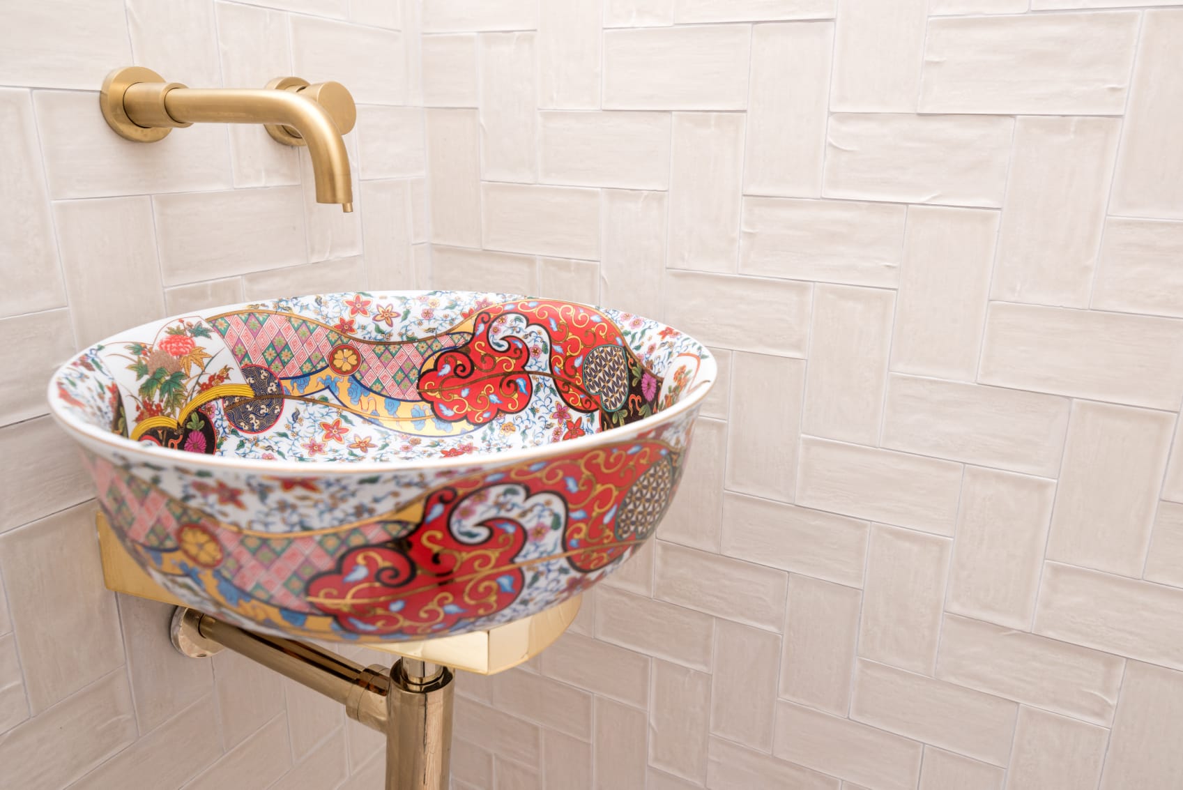 Cloakroom renovation with patterned basin, brushed brass taps and wall-hung toilet by Maxfix in Fulham