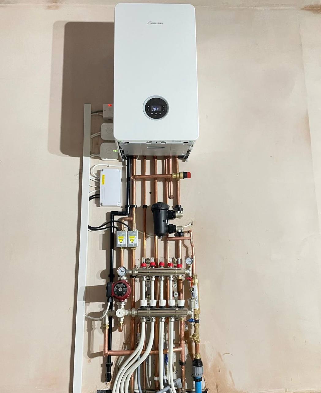 Worcester Bosch boiler installation with manifold and copper pipework in South West London