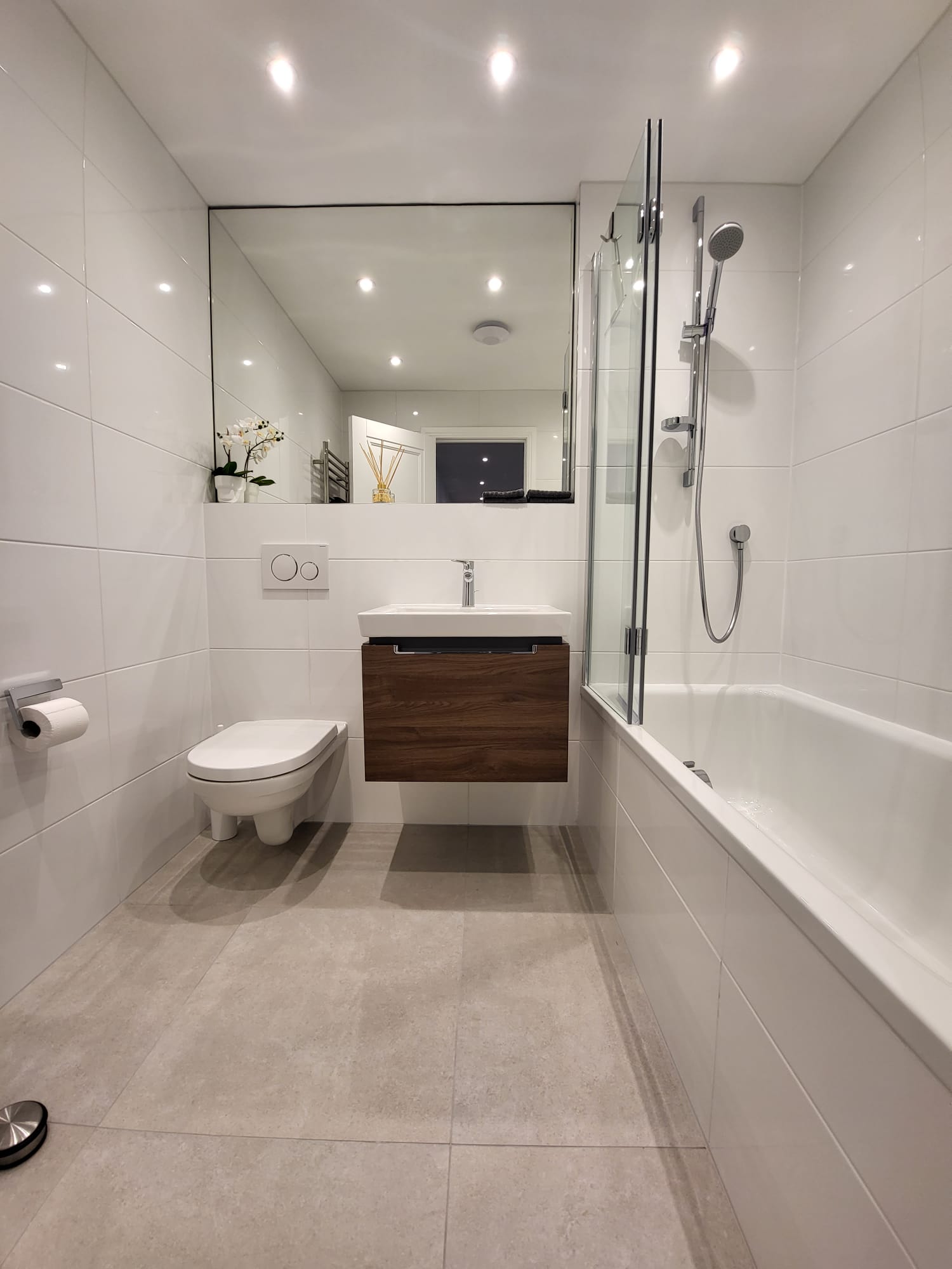 Full bathroom renovation from first fix to finish with Geberit wall-hung toilet, concealed shower valve and walnut vanity unit by Maxfix in Chelsea