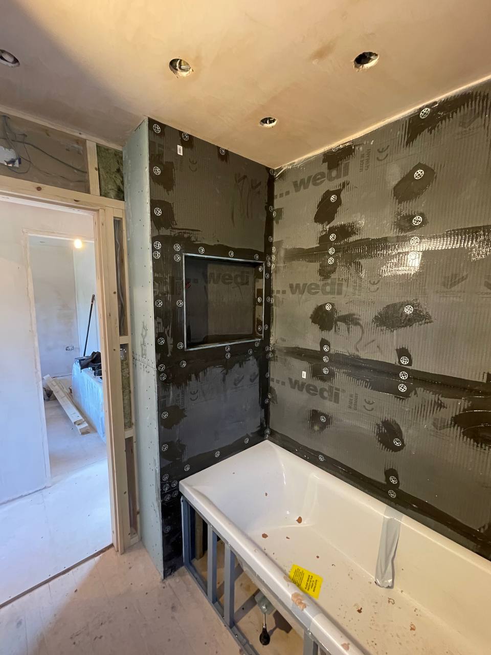 Wedi waterproof tanking boards installed before tiling in a South West London bathroom