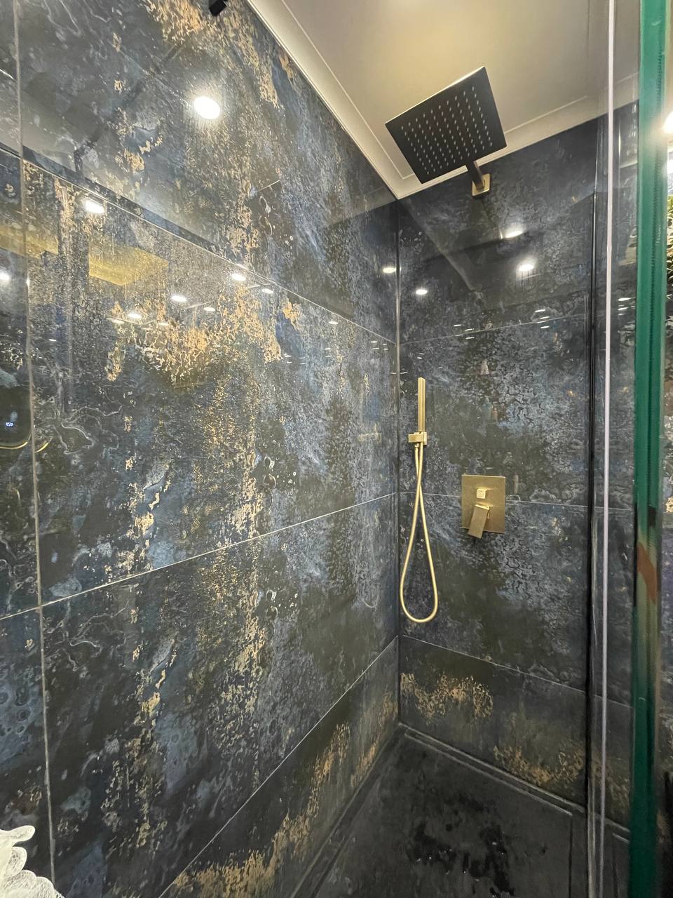 Walk-in shower room with rainfall head and tiled walls in South West London