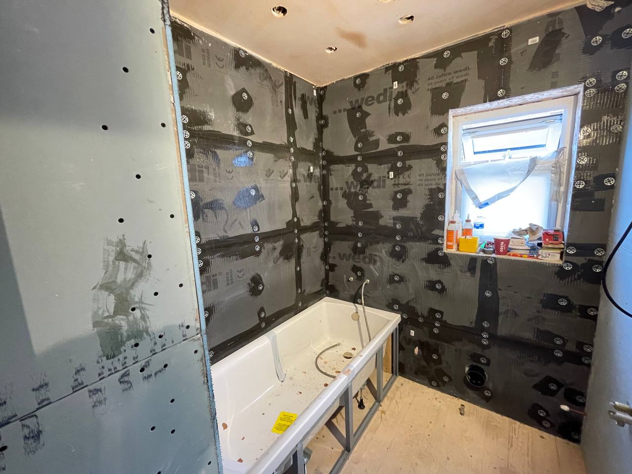 Bathroom first-fix with Wedi waterproof tanking boards and bath ready for tiling in South West London