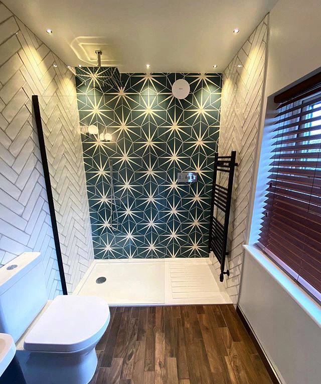 Walk-in shower with green star feature tiling and white herringbone walls in South West London