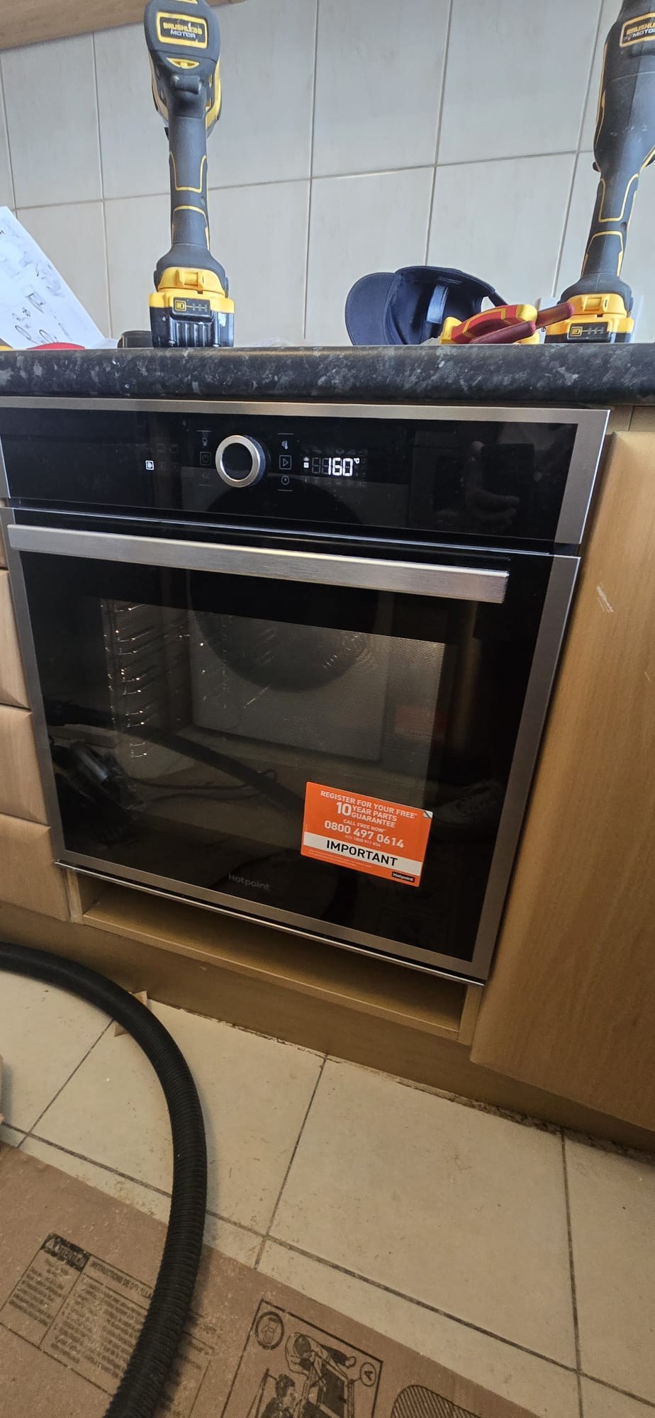 Built-in Hotpoint oven installation in a kitchen by Maxfix in KT2