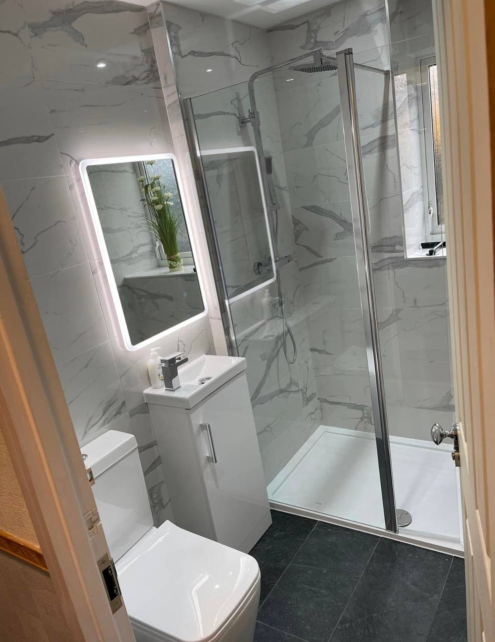 Renovated bathroom with bath, vanity and tiling in South West London