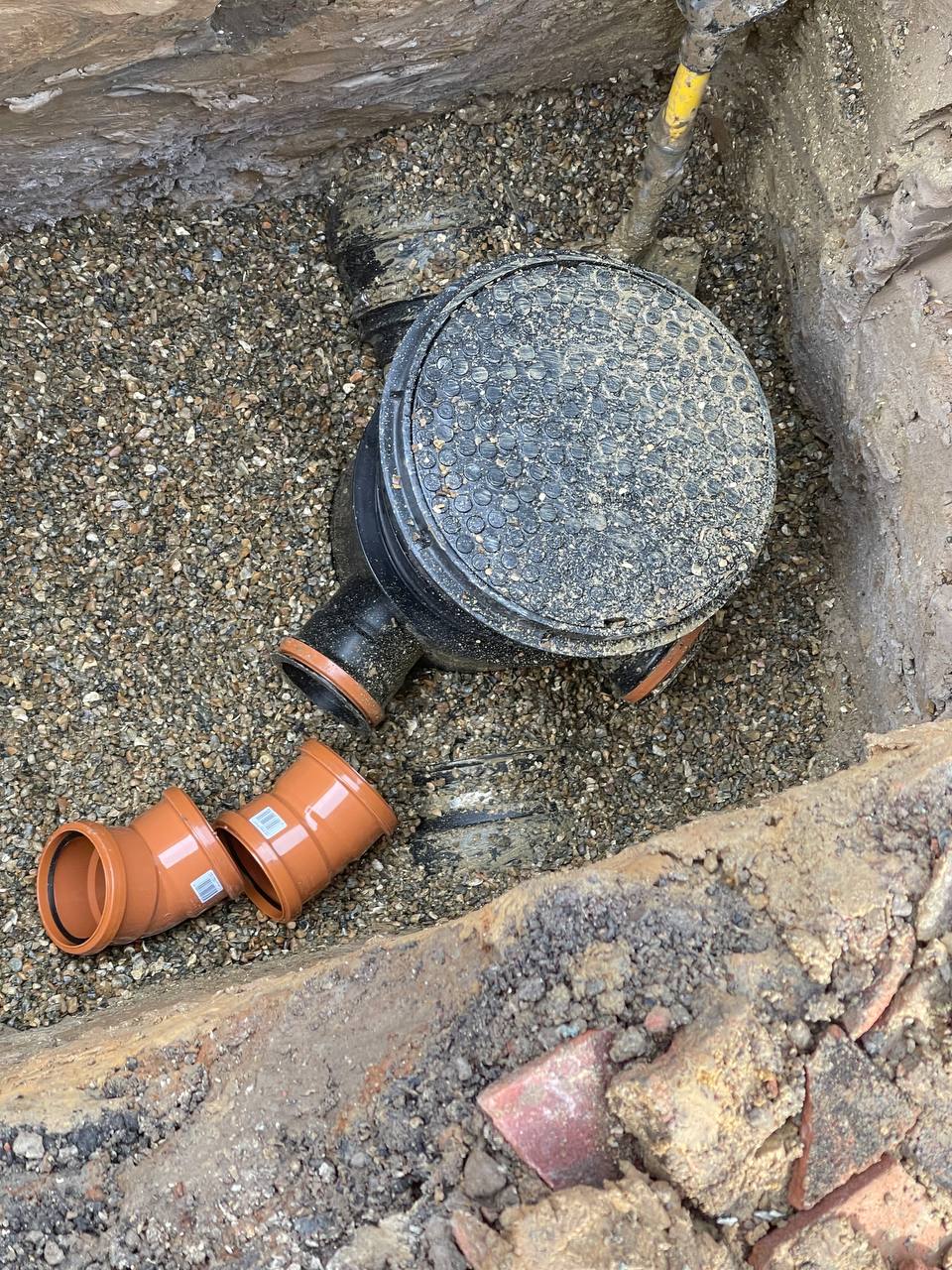 Emergency plumber repairing pipework in South West London