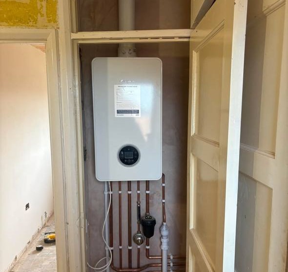 Gas Safe engineer carrying out a boiler repair in South West London